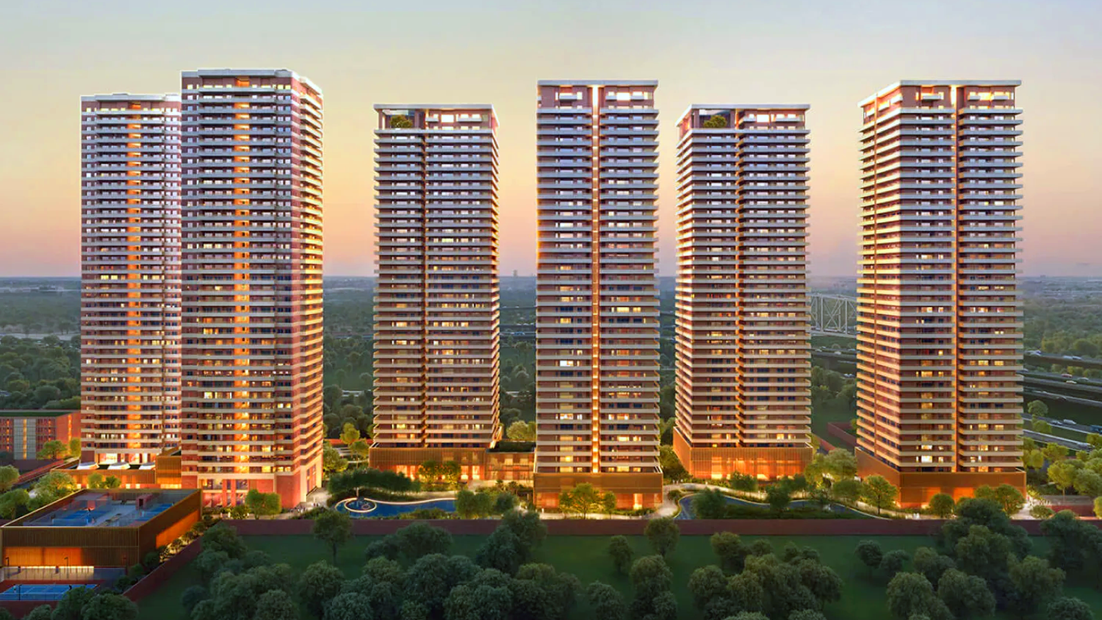 Tall modern buildings with blue sky and green trees in front
